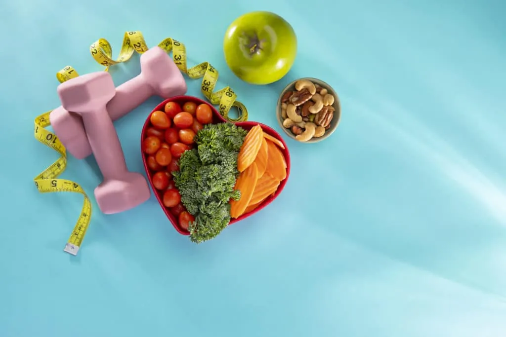 Healthy food, dumbbells and a tape measure laid out ahead of treatment
